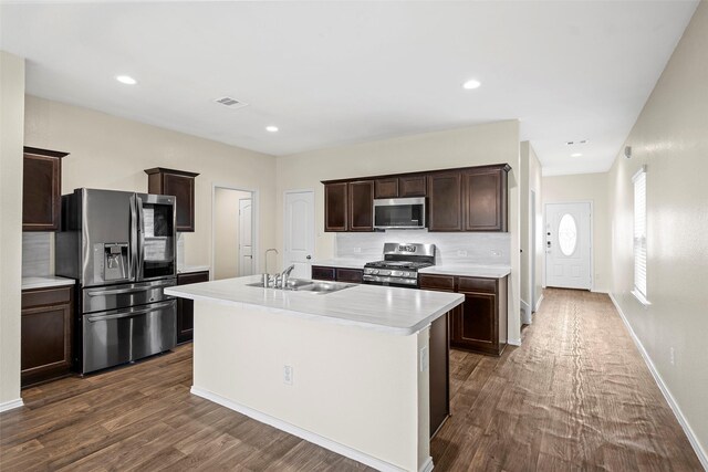 kitchen featuring dark brown cabinets, appliances with stainless steel finishes, a sink, and visible vents