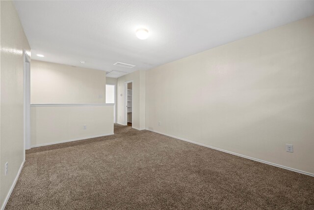 empty room featuring baseboards and carpet flooring