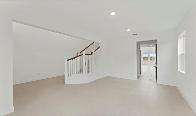 empty room with stairway, baseboards, recessed lighting, and visible vents