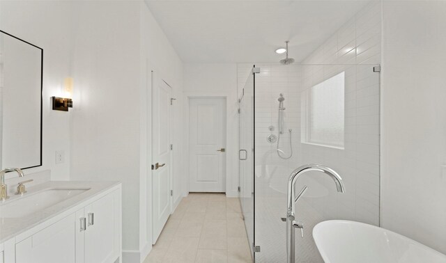 full bathroom featuring vanity, a freestanding tub, tile patterned flooring, and a shower stall