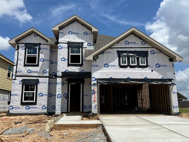 property in mid-construction featuring driveway and a garage