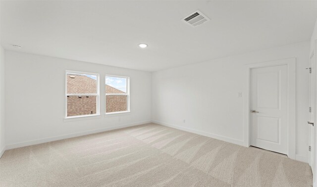 unfurnished room featuring baseboards, light carpet, recessed lighting, and visible vents