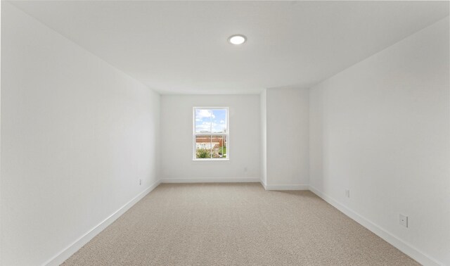 unfurnished room featuring baseboards, light carpet, and recessed lighting