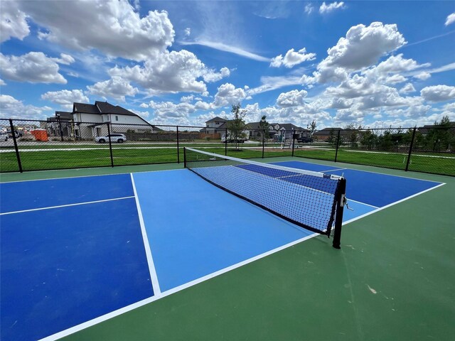 view of sport court with fence