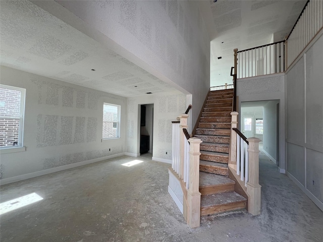 21238 Blue Bluff Dr, Cypress, TX 77433 - stairs featuring a towering ceiling and baseboards
