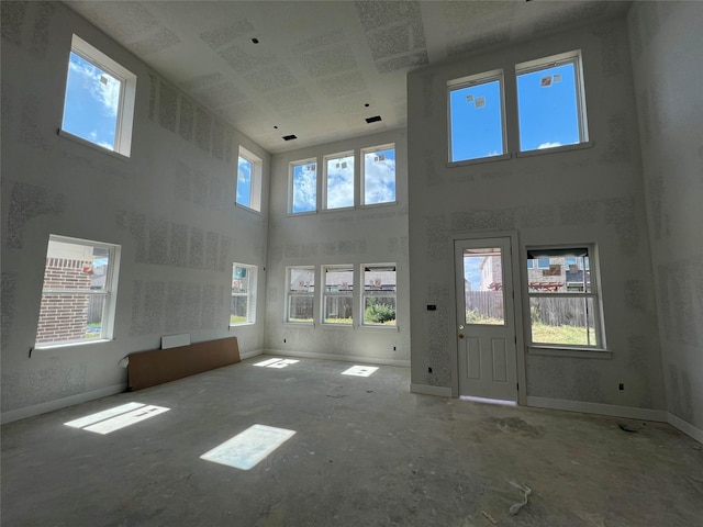 21238 Blue Bluff Dr, Cypress, TX 77433 - unfurnished living room with a towering ceiling and baseboards