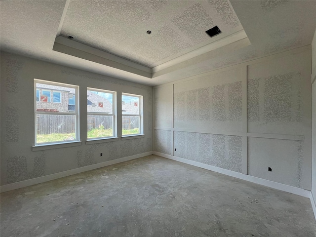 21238 Blue Bluff Dr, Cypress, TX 77433 - unfurnished room featuring concrete floors, a raised ceiling, and a textured ceiling