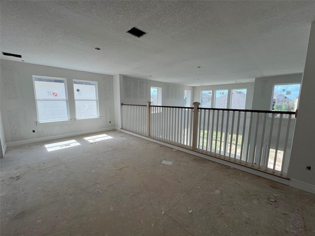 21238 Blue Bluff Dr, Cypress, TX 77433 - empty room featuring a textured ceiling and baseboards