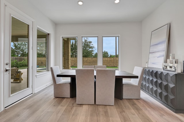 unfurnished dining area with baseboards, plenty of natural light, recessed lighting, and light wood-style flooring