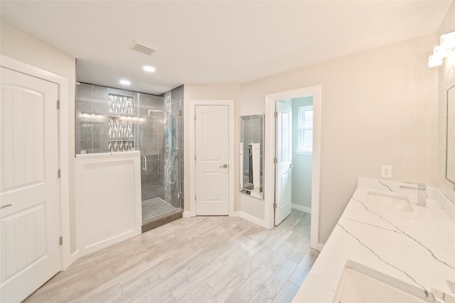 bathroom with visible vents, wood finished floors, baseboards, recessed lighting, and a stall shower