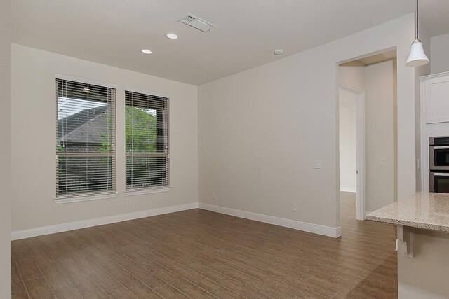 249 Palomino Ct, The Woodlands, TX 77382 - spare room featuring recessed lighting, dark wood-type flooring, and baseboards