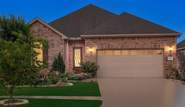 249 Palomino Ct, The Woodlands, TX 77382 - french country style house with brick siding, driveway, an attached garage, roof with shingles, and a front yard