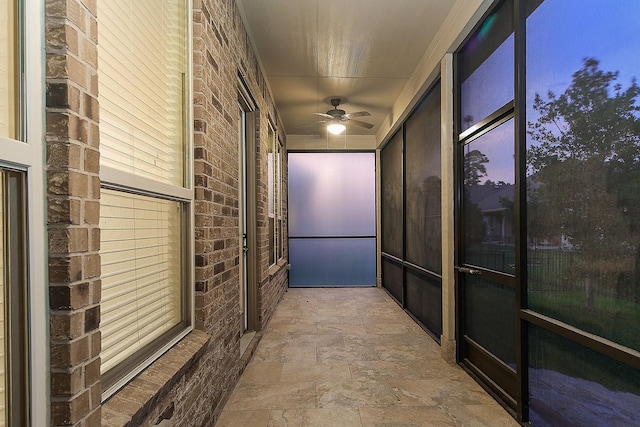249 Palomino Ct, The Woodlands, TX 77382 - hall featuring stone finish flooring and brick wall