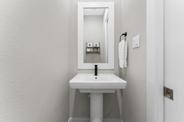 bathroom with a textured wall