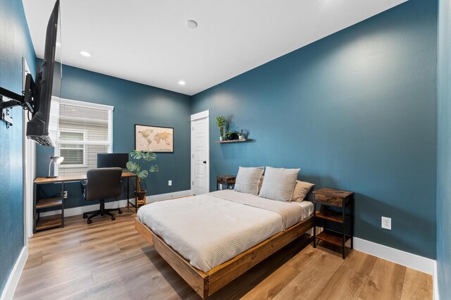 bedroom featuring baseboards, recessed lighting, and light wood-style flooring