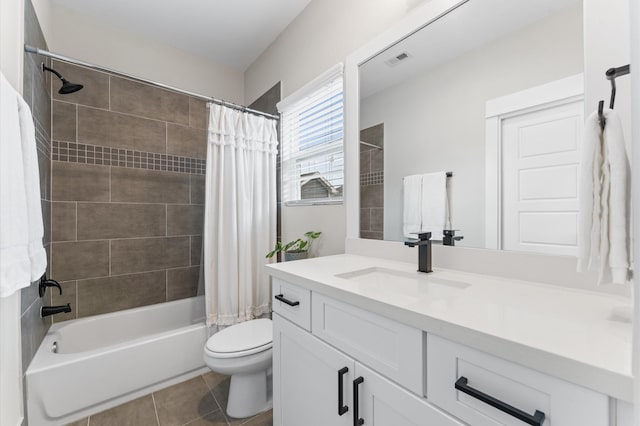 full bathroom with tile patterned flooring, vanity, shower / tub combo with curtain, toilet, and visible vents