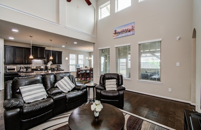 7610 River Pass Dr, Pearland, TX 77581 - living area with a high ceiling, wood-type flooring, arched walkways, plenty of natural light, and a ceiling fan
