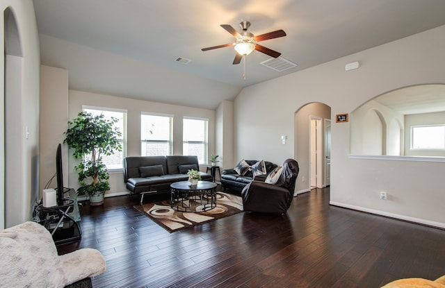 7610 River Pass Dr, Pearland, TX 77581 - living area with arched walkways, ceiling fan, dark wood finished floors, and visible vents