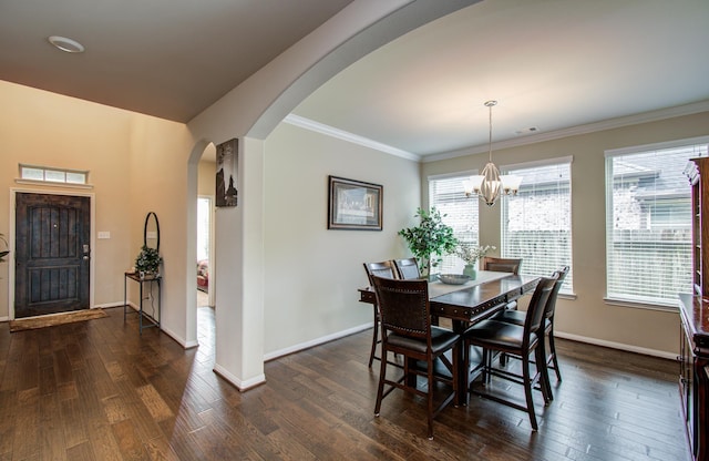 7610 River Pass Dr, Pearland, TX 77581 - dining space with arched walkways, baseboards, dark wood finished floors, and an inviting chandelier