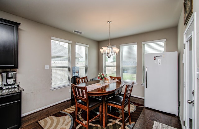 7610 River Pass Dr, Pearland, TX 77581 - dining space with baseboards, a chandelier, dark wood-style floors, and visible vents