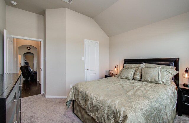 7610 River Pass Dr, Pearland, TX 77581 - bedroom featuring visible vents, lofted ceiling, light carpet, baseboards, and arched walkways