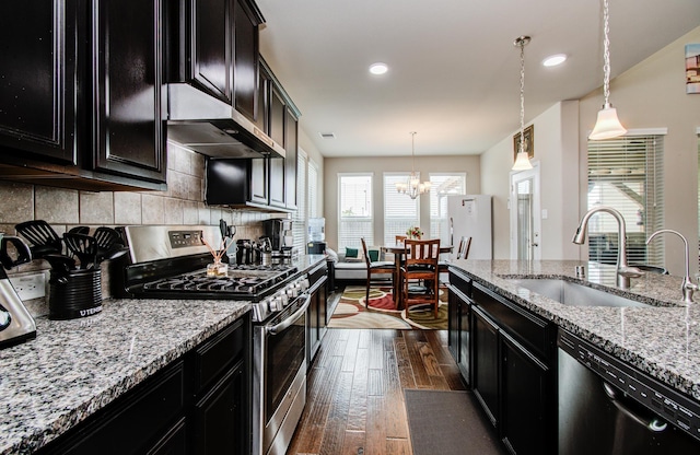 7610 River Pass Dr, Pearland, TX 77581 - kitchen featuring stainless steel gas range, dark cabinetry, and black dishwasher