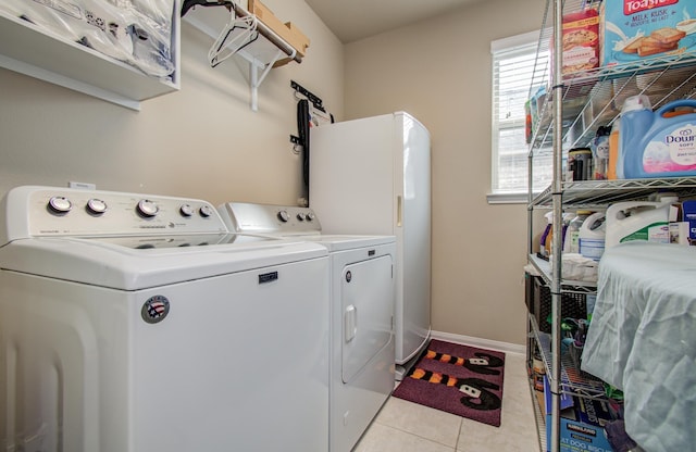 7610 River Pass Dr, Pearland, TX 77581 - clothes washing area with baseboards, laundry area, light tile patterned flooring, and washer and dryer