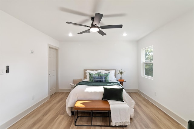 bedroom with baseboards, recessed lighting, light wood-style flooring, and ceiling fan