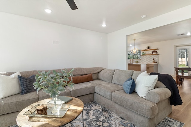 living area featuring recessed lighting, ceiling fan, visible vents, and light wood-style flooring