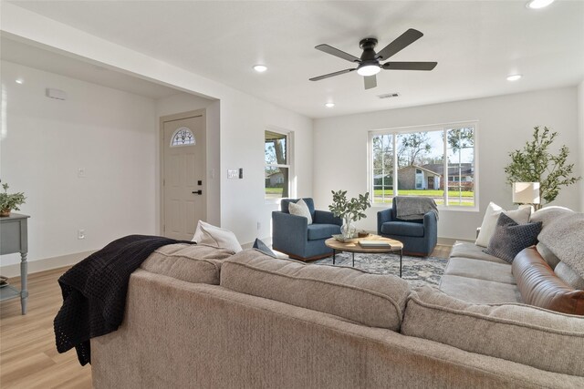 living room with visible vents, baseboards, ceiling fan, recessed lighting, and light wood-type flooring