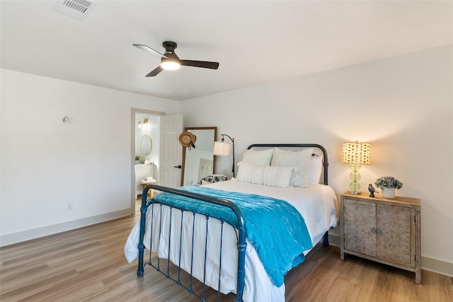 bedroom featuring visible vents, a ceiling fan, baseboards, and wood finished floors