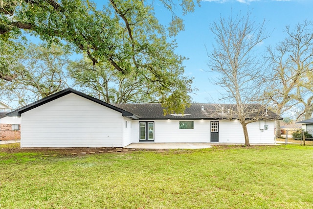 rear view of property with a patio, a lawn, fence, and roof with shingles