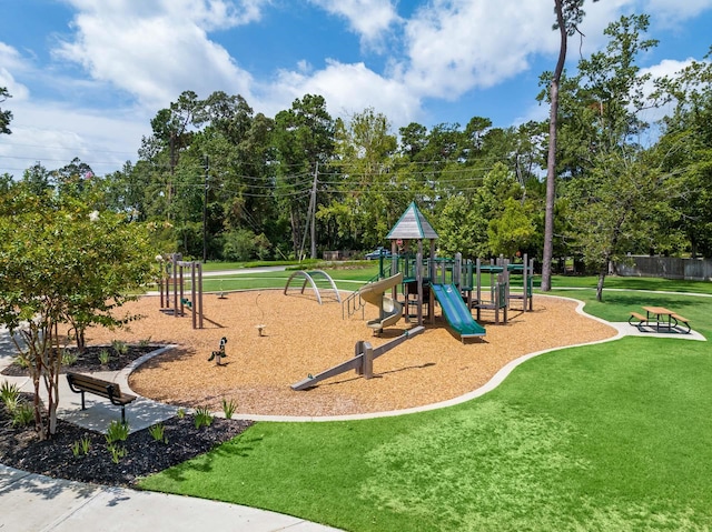 community playground featuring fence and a yard