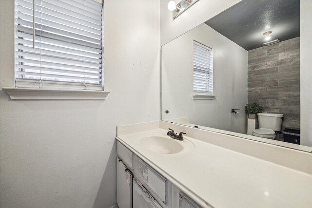 bathroom featuring toilet and vanity
