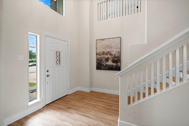 14206 Barker Bayou Ct, Cypress, TX 77429 - foyer featuring wood finished floors, baseboards, and a high ceiling