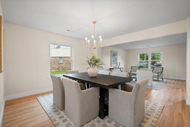 14206 Barker Bayou Ct, Cypress, TX 77429 - dining room with a chandelier, light wood finished floors, and baseboards