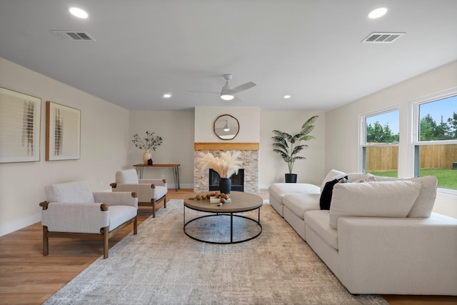 14206 Barker Bayou Ct, Cypress, TX 77429 - living room with wood finished floors, recessed lighting, baseboards, ceiling fan, and a stone fireplace