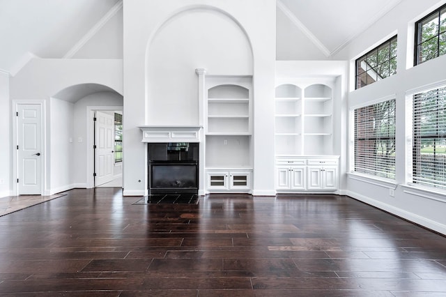 4703 Shadow Grass Dr, Katy, TX 77493 - unfurnished living room featuring arched walkways, a high end fireplace, high vaulted ceiling, built in shelves, and baseboards