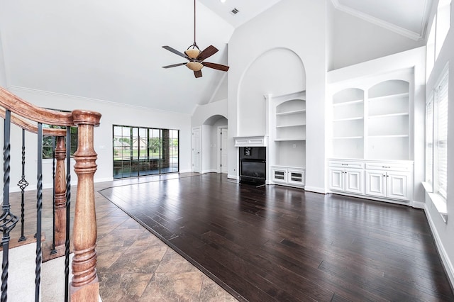 4703 Shadow Grass Dr, Katy, TX 77493 - unfurnished living room with high vaulted ceiling, ceiling fan, built in shelves, baseboards, and dark wood-type flooring