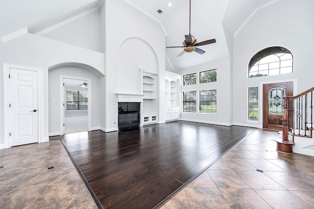 4703 Shadow Grass Dr, Katy, TX 77493 - unfurnished living room with a ceiling fan, built in features, baseboards, high vaulted ceiling, and stairway