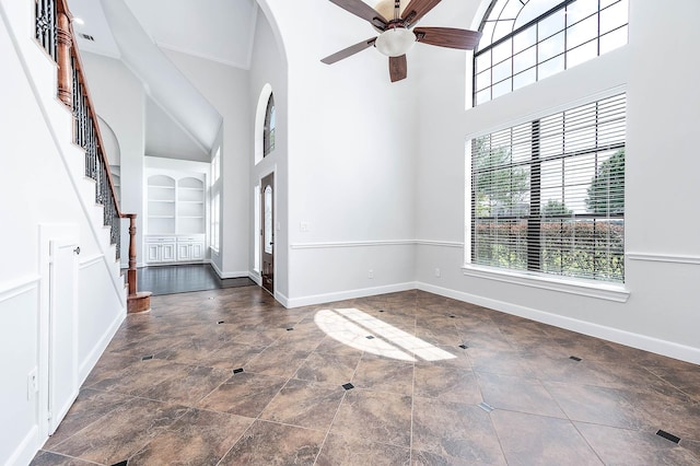 4703 Shadow Grass Dr, Katy, TX 77493 - entrance foyer featuring a high ceiling, a ceiling fan, baseboards, stairs, and arched walkways