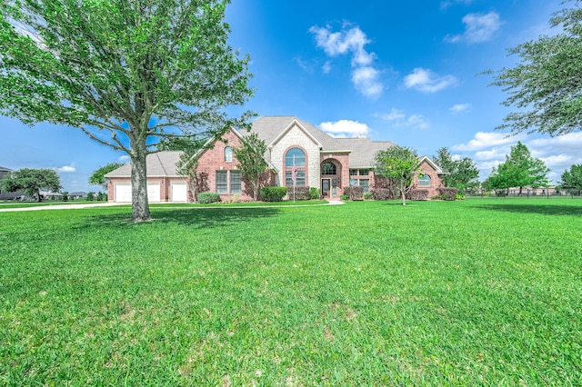 4703 Shadow Grass Dr, Katy, TX 77493 - view of front of home featuring a front yard, an attached garage, brick siding, and stone siding