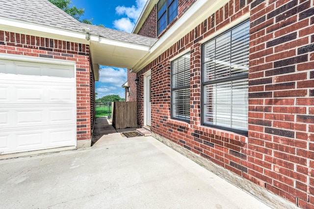 4703 Shadow Grass Dr, Katy, TX 77493 - view of side of property featuring brick siding, a shingled roof, a garage, fence, and a gate