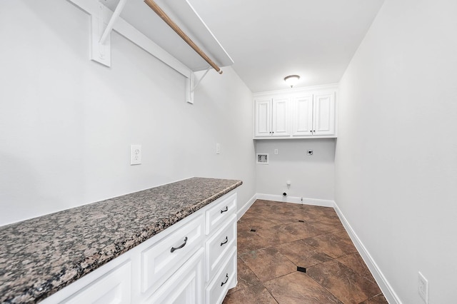 4703 Shadow Grass Dr, Katy, TX 77493 - laundry area with hookup for an electric dryer, hookup for a washing machine, gas dryer hookup, baseboards, and stone finish floors