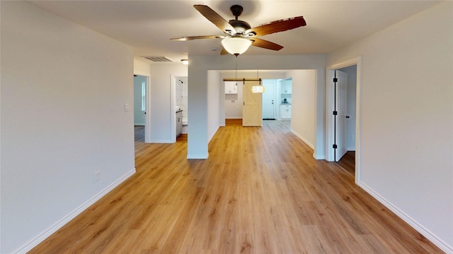 1002 Francis Dr, Pasadena, TX 77506 - unfurnished room featuring a ceiling fan, light wood-style flooring, and baseboards