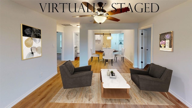1002 Francis Dr, Pasadena, TX 77506 - living room with light wood-style floors, baseboards, and ceiling fan