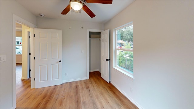 1002 Francis Dr, Pasadena, TX 77506 - unfurnished bedroom featuring light wood finished floors, a closet, baseboards, and ceiling fan