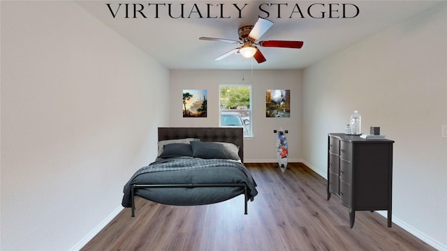 1002 Francis Dr, Pasadena, TX 77506 - bedroom with wood finished floors, baseboards, and a ceiling fan