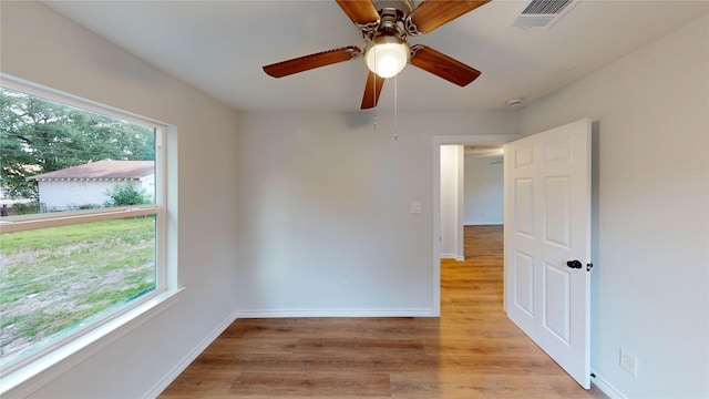 1002 Francis Dr, Pasadena, TX 77506 - unfurnished room with healthy amount of natural light, light wood-type flooring, baseboards, and ceiling fan