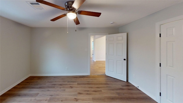 1002 Francis Dr, Pasadena, TX 77506 - unfurnished bedroom featuring wood finished floors, baseboards, and a ceiling fan